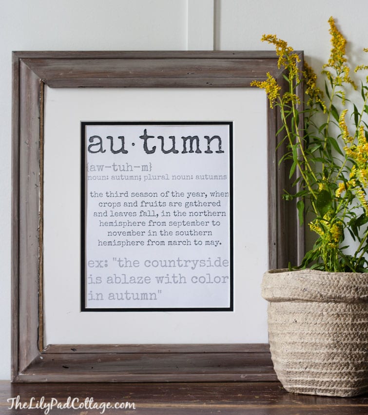 A vase of flowers sits in front of a sign