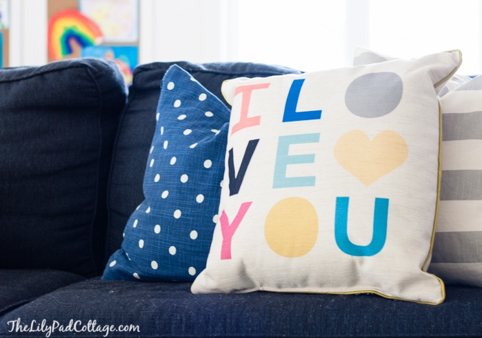 A blue sofa with colorful pillows