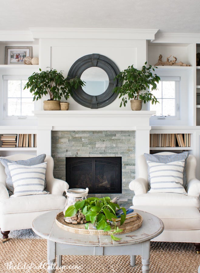 A living room filled with furniture and vase of flowers on a table