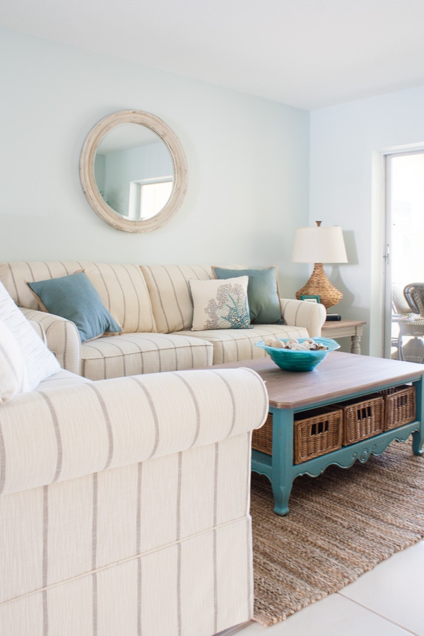 A living room with a bed and chair