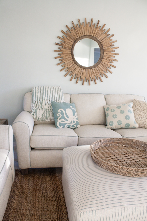 A living room with sofa and mirror