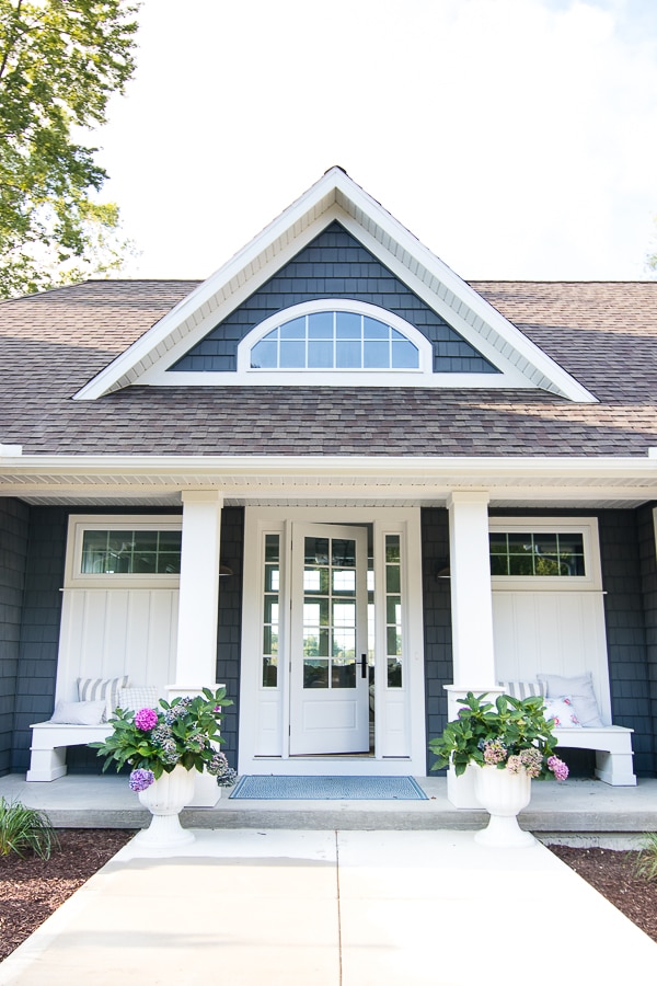 A lake house front porch with benches