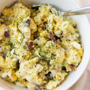 A bowl of food on a plate, with Salad