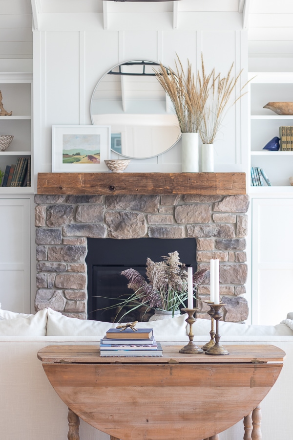 A fire place sitting in a living room filled with furniture 