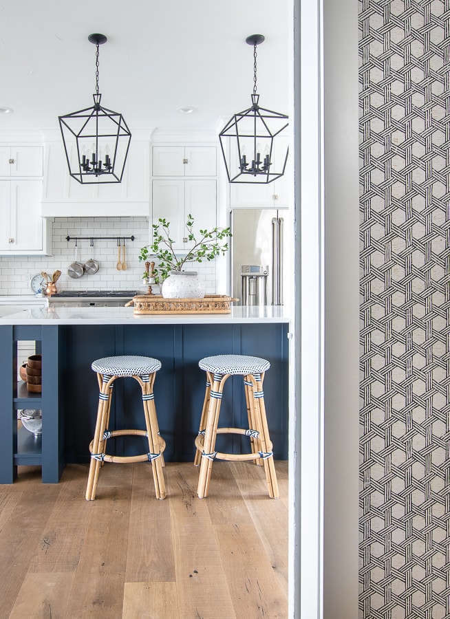 A navy kitchen island with stools