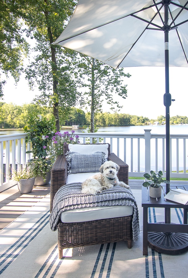 striped rug, pottery barn wicker furniture, white umbrella