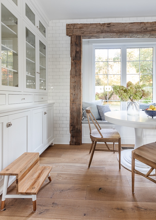 breakfast nook rustic beams white round table wood chairs