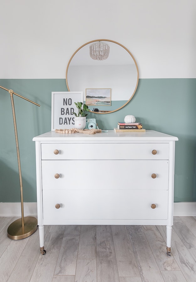 white dresser, brass accents, round mirror