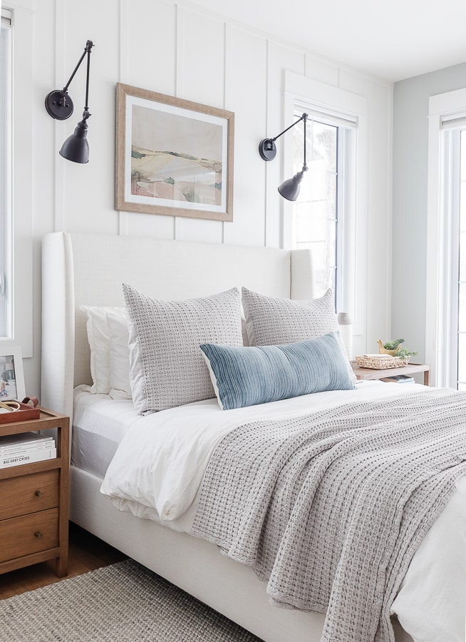 white duvet cover, gray waffle knit throw blanket and pillow. Lake house bedroom.