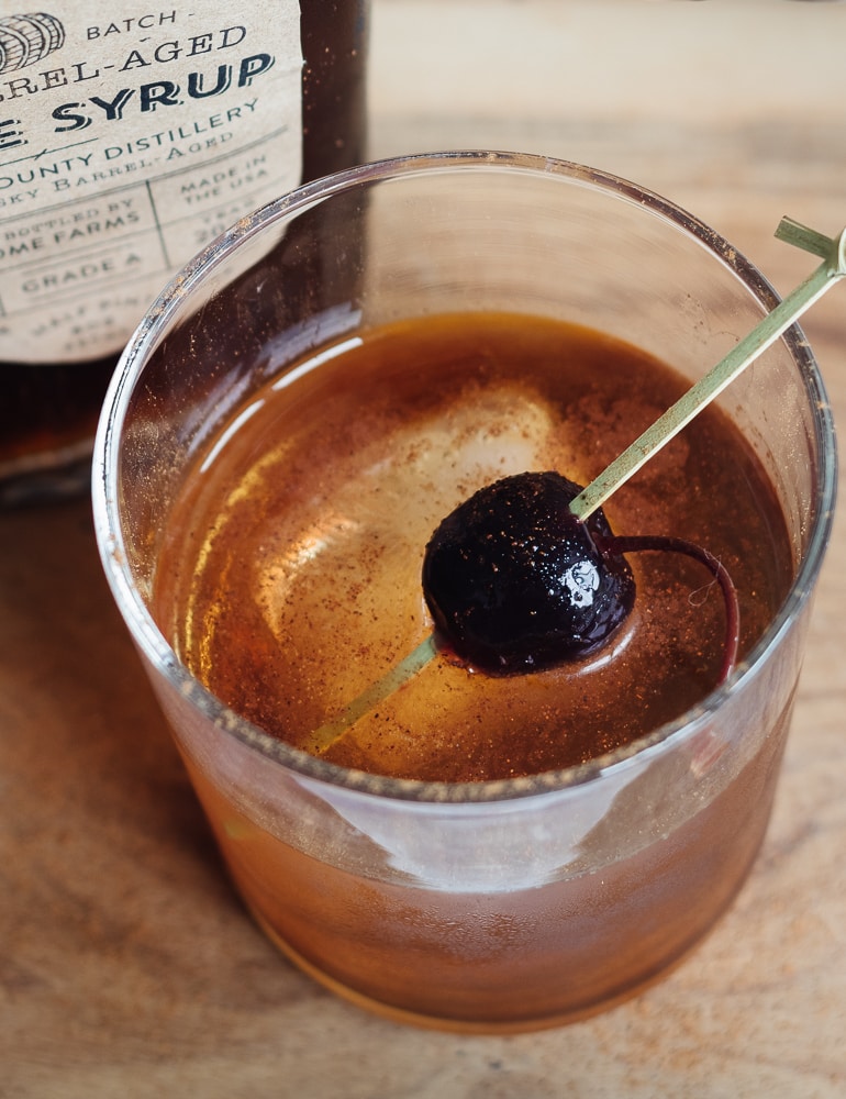 A glass on a table, with Maple Manhattan