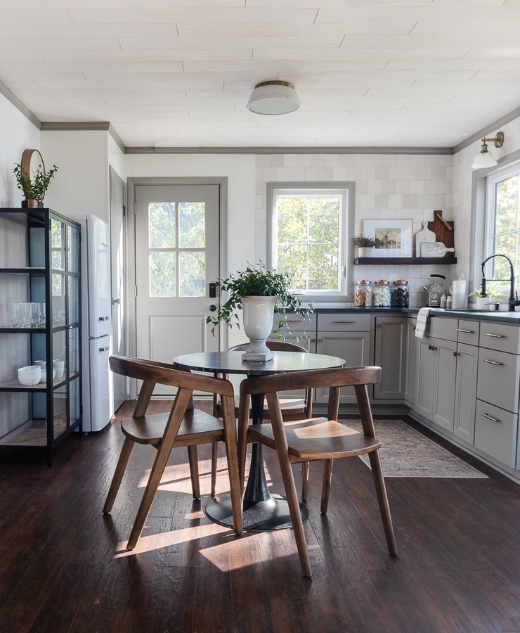 A kitchen with wooden cabinets and a dining room table