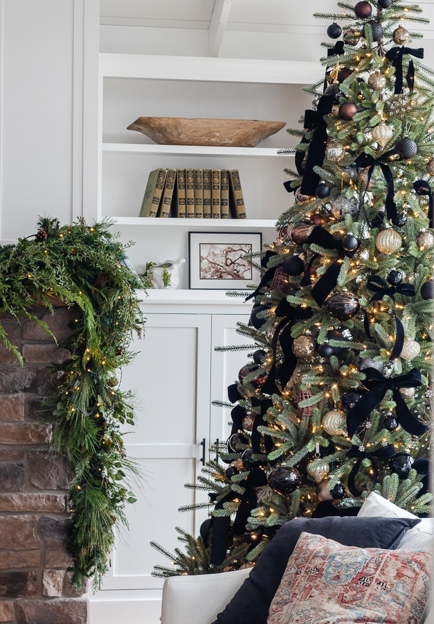 A living room filled with a Christmas tree and garland