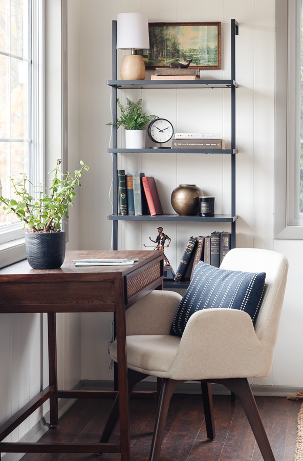 dark wood floors, small desk and cloth chair with ladder style desk chair