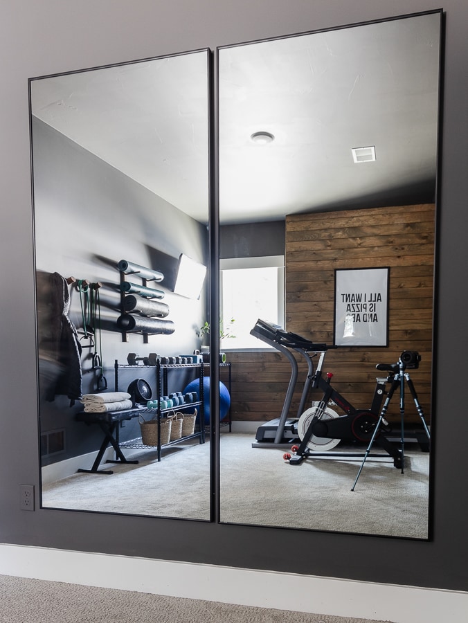 Home gym with large mirrors and exercise equipment