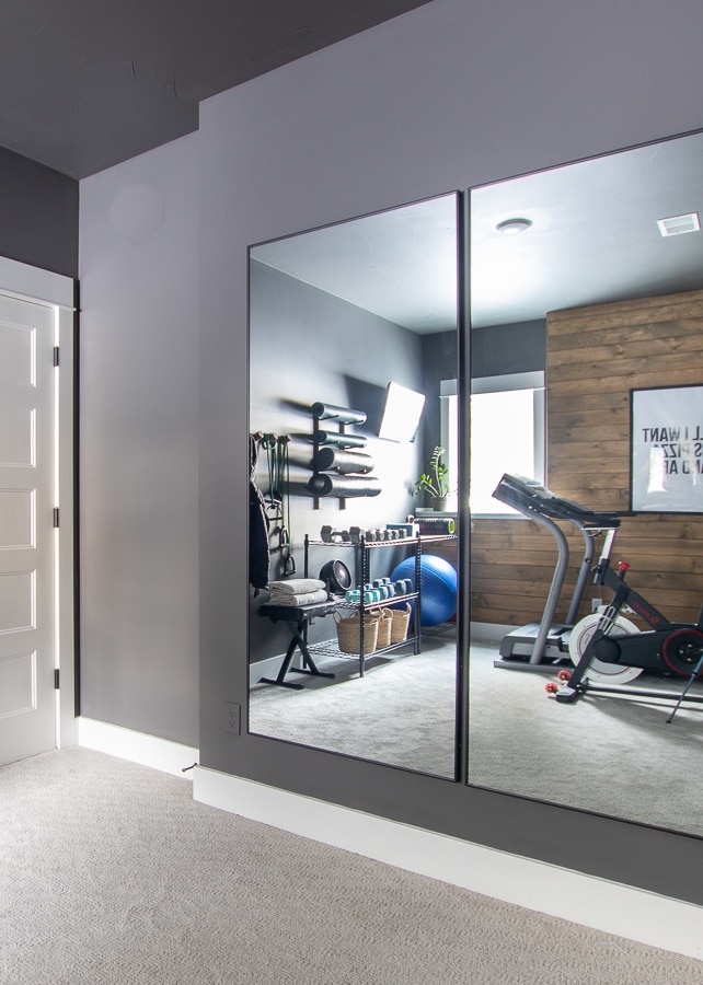 Gym wall mirrors with gray paint and exercise equipment