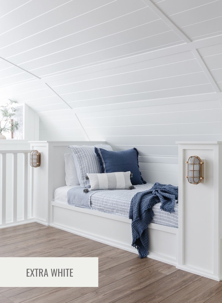 white bunk room with blue bedding