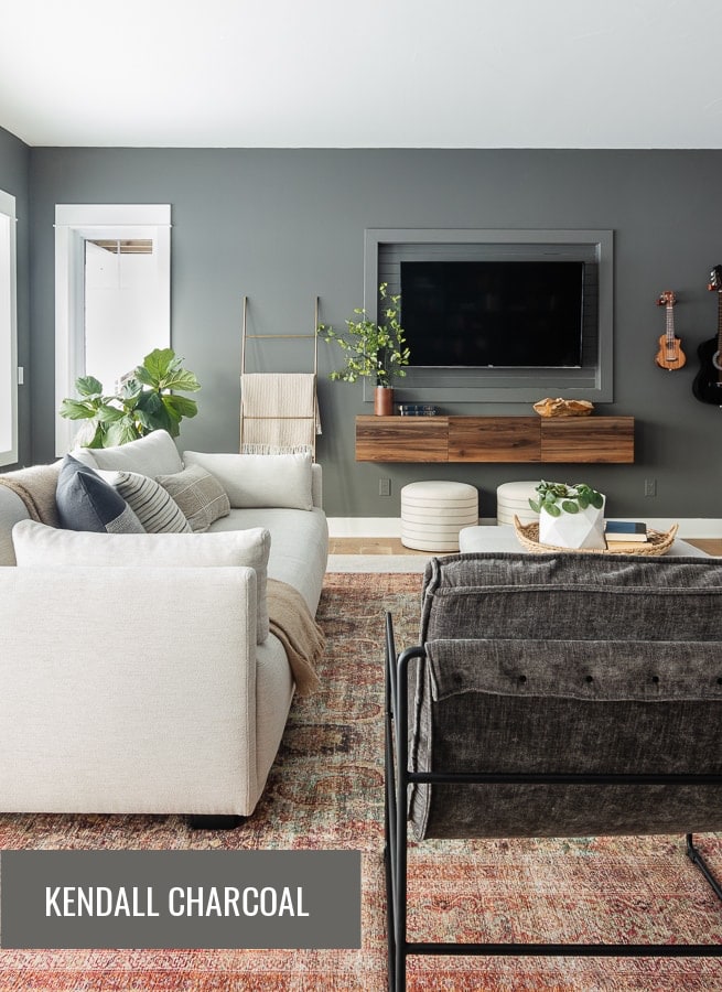 family room with white sofa, terra-cotta colored rug and dark gray walls
