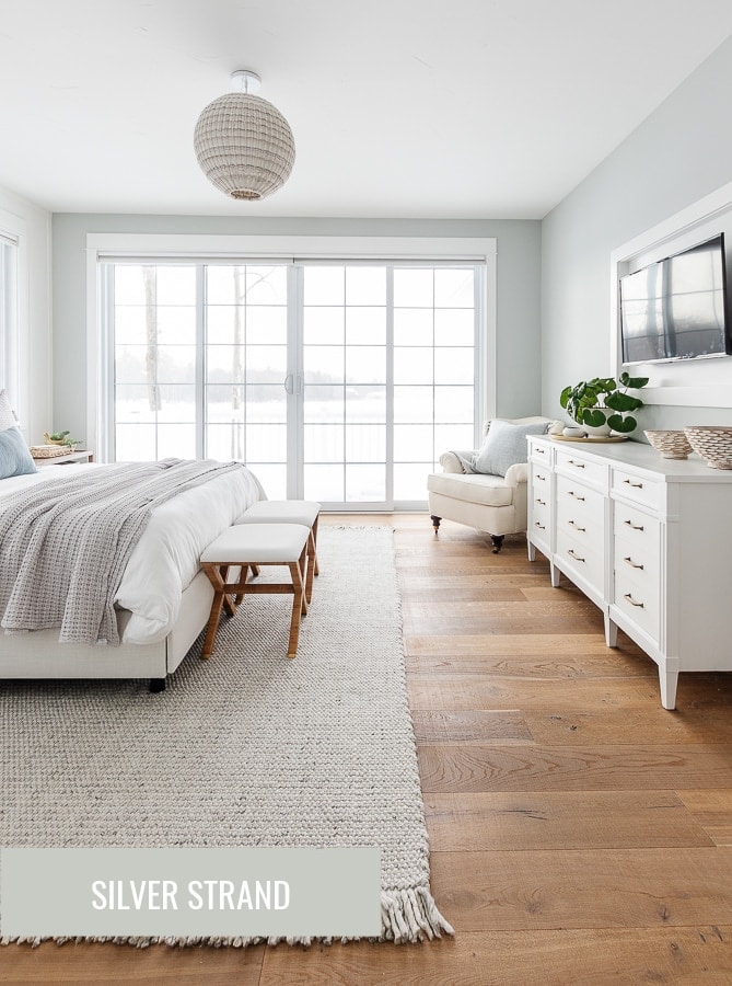 bedroom with large sliding doors and gray rug