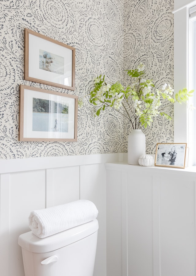 anthropologie wallpaper in a small bathroom with white board and batten