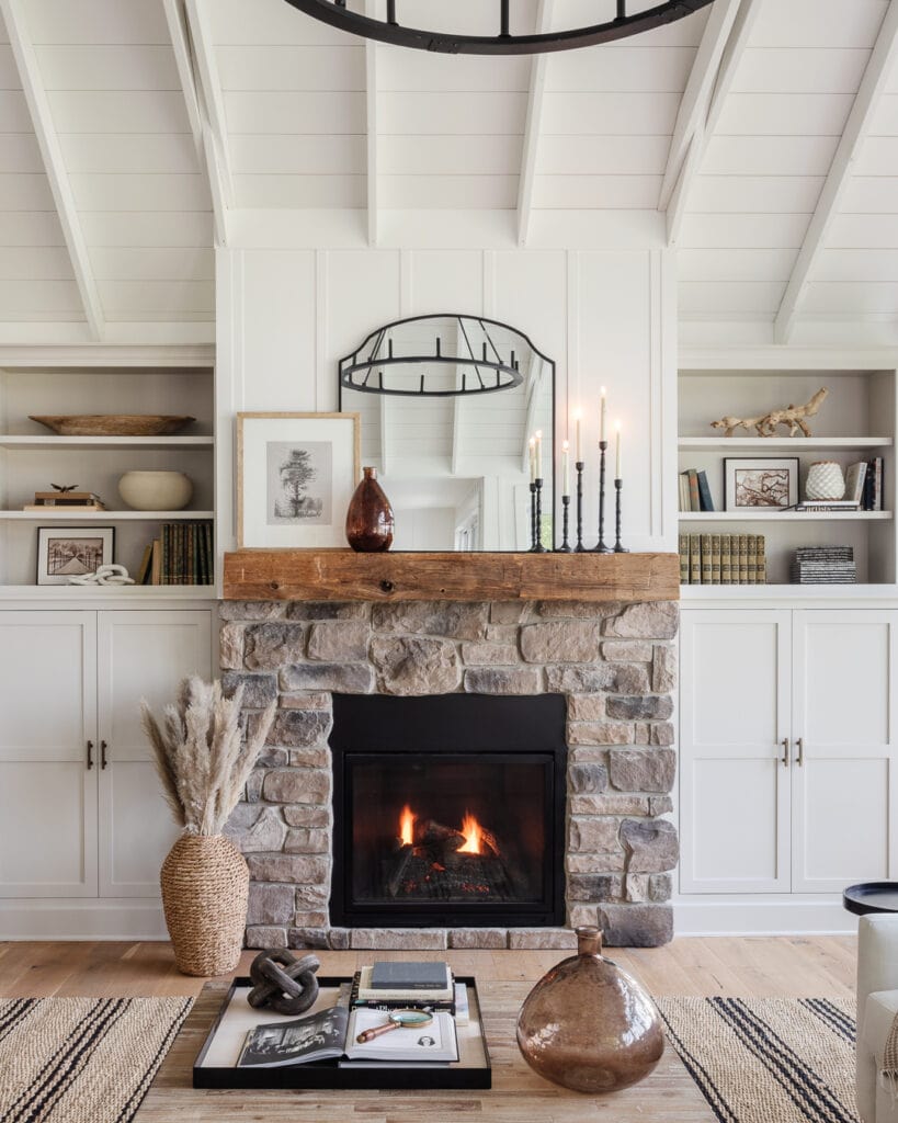 stone fireplace with mirror and candles