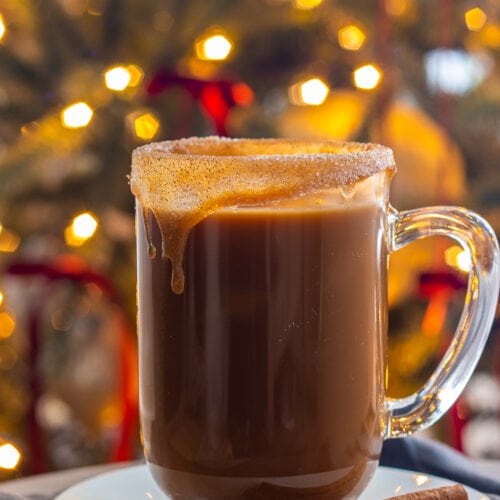 Coffee cup with caramel rim and christmas lights