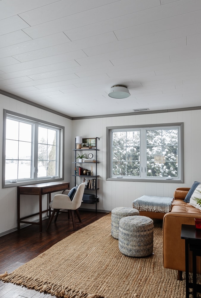 desk space with leather sofa and planked ceilings