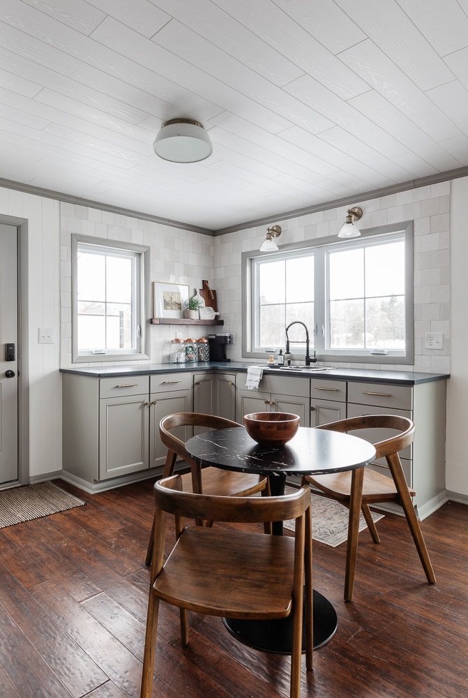 gray and white kitchen with black countertops 