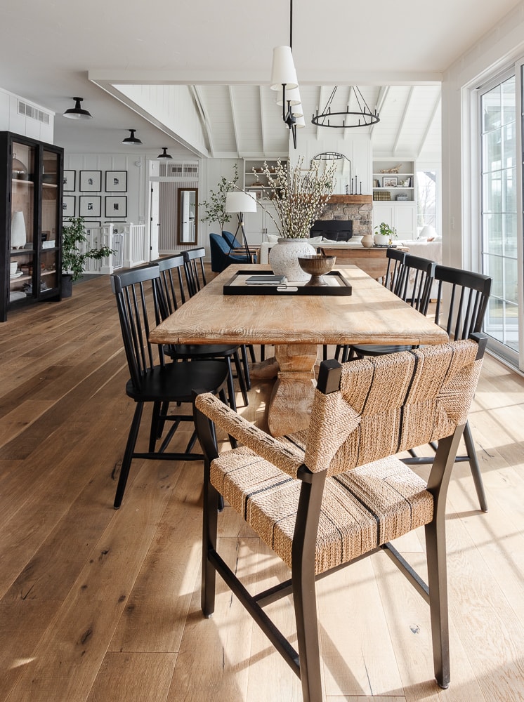 lake house dining room with wood table and black chairs
