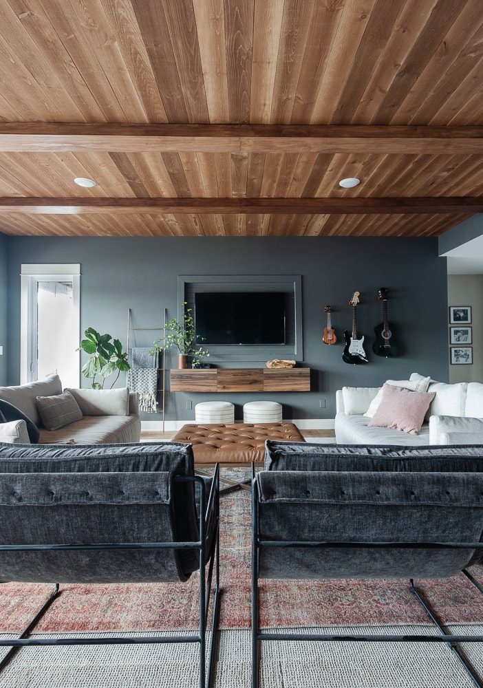 Dark gray room with tv and wood ceilings