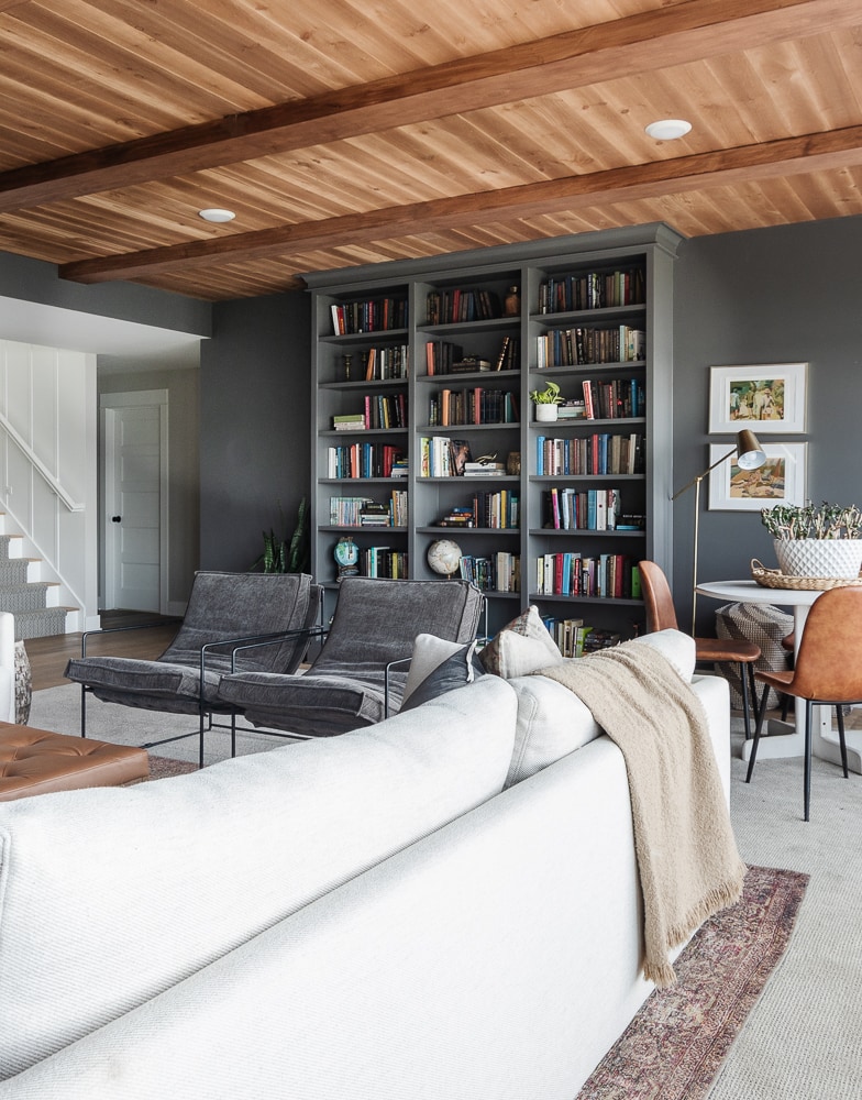 dark gray walls and bookcase with wood ceilings