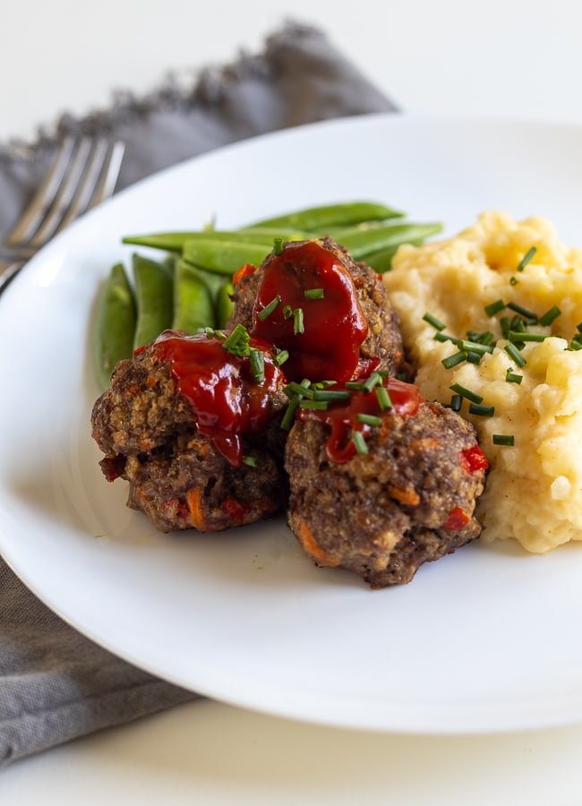 Meatloaf Meatballs on a plate with mashed potatoes and peas