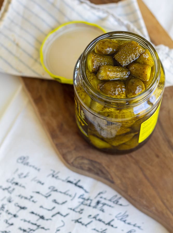 jar of pickles on a wooden cutting board 