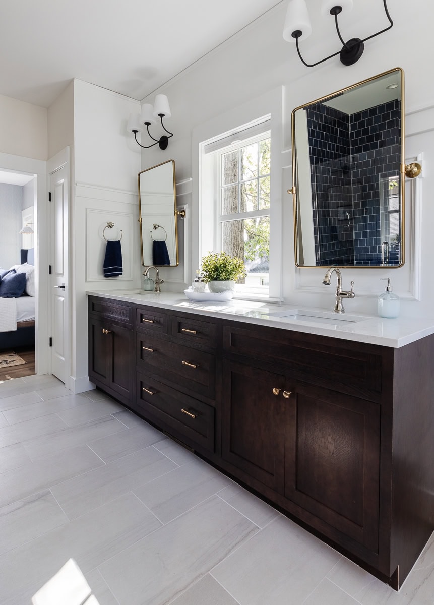 walnut cabinets with brass mirrors in bathroom