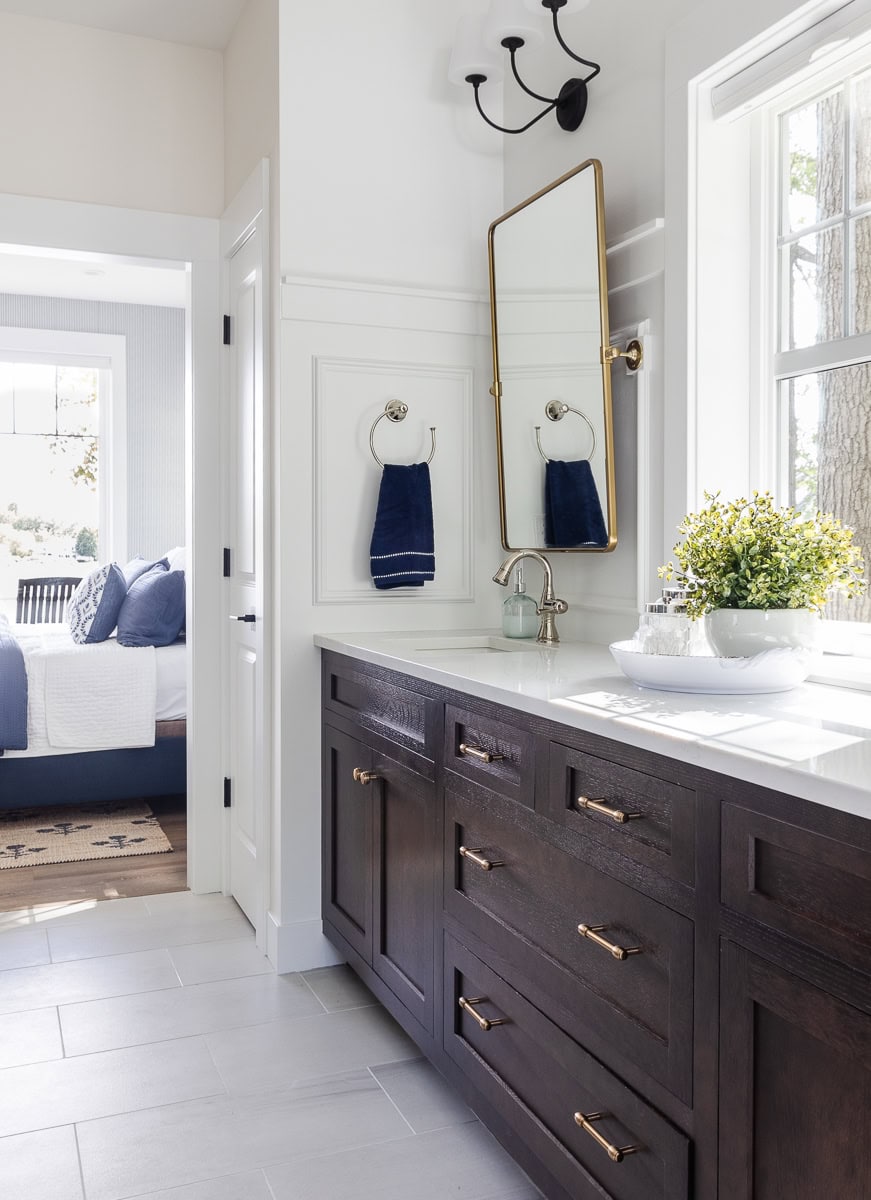 navy and white bathroom with walnut cabinets
