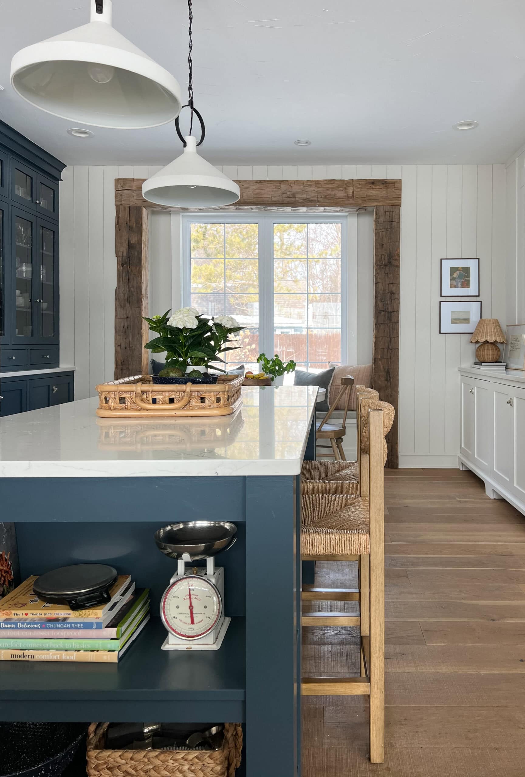 white kitchen with navy island and beige walls
