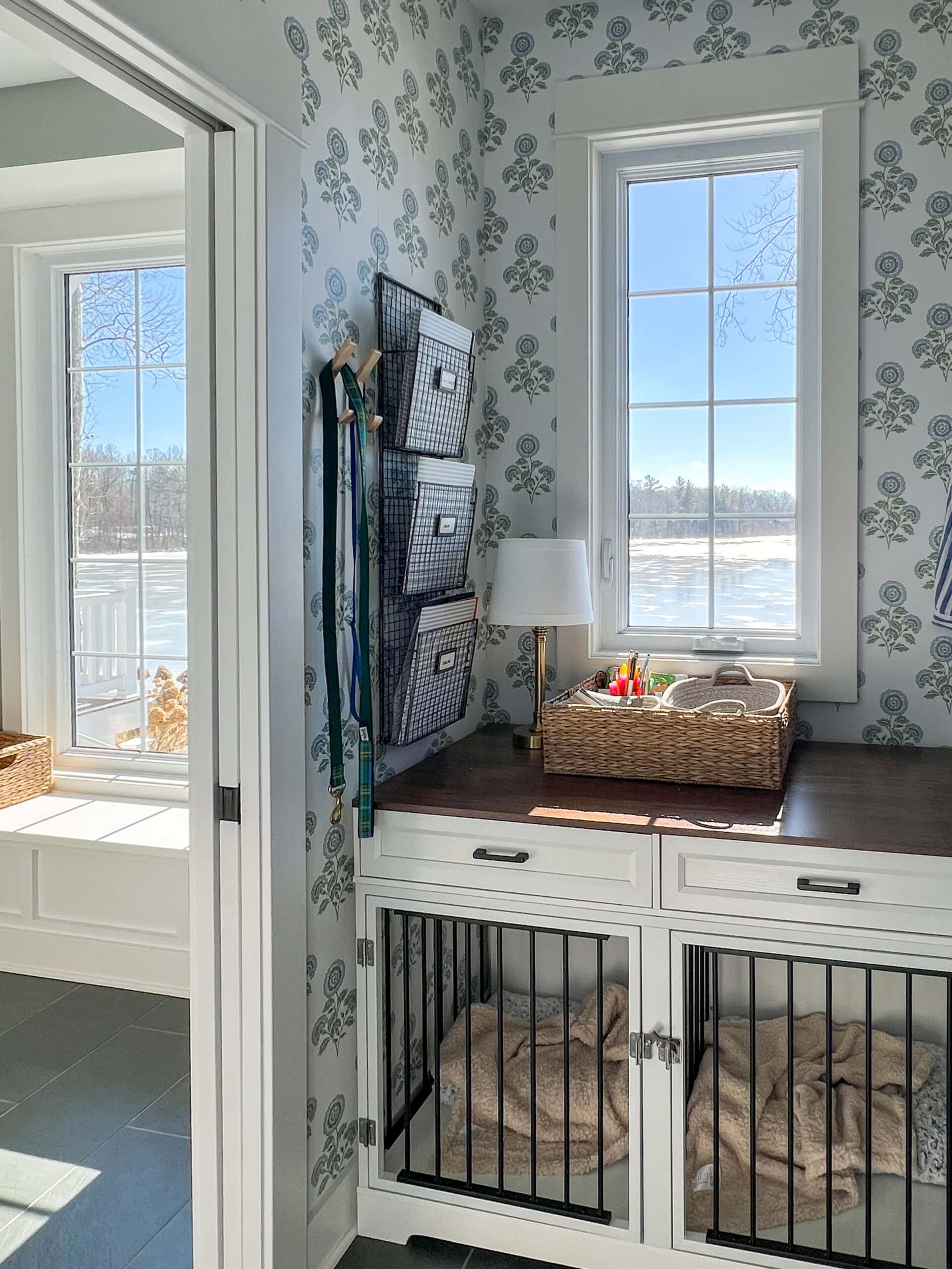 dog kennel in laundry room with floral wallpaper