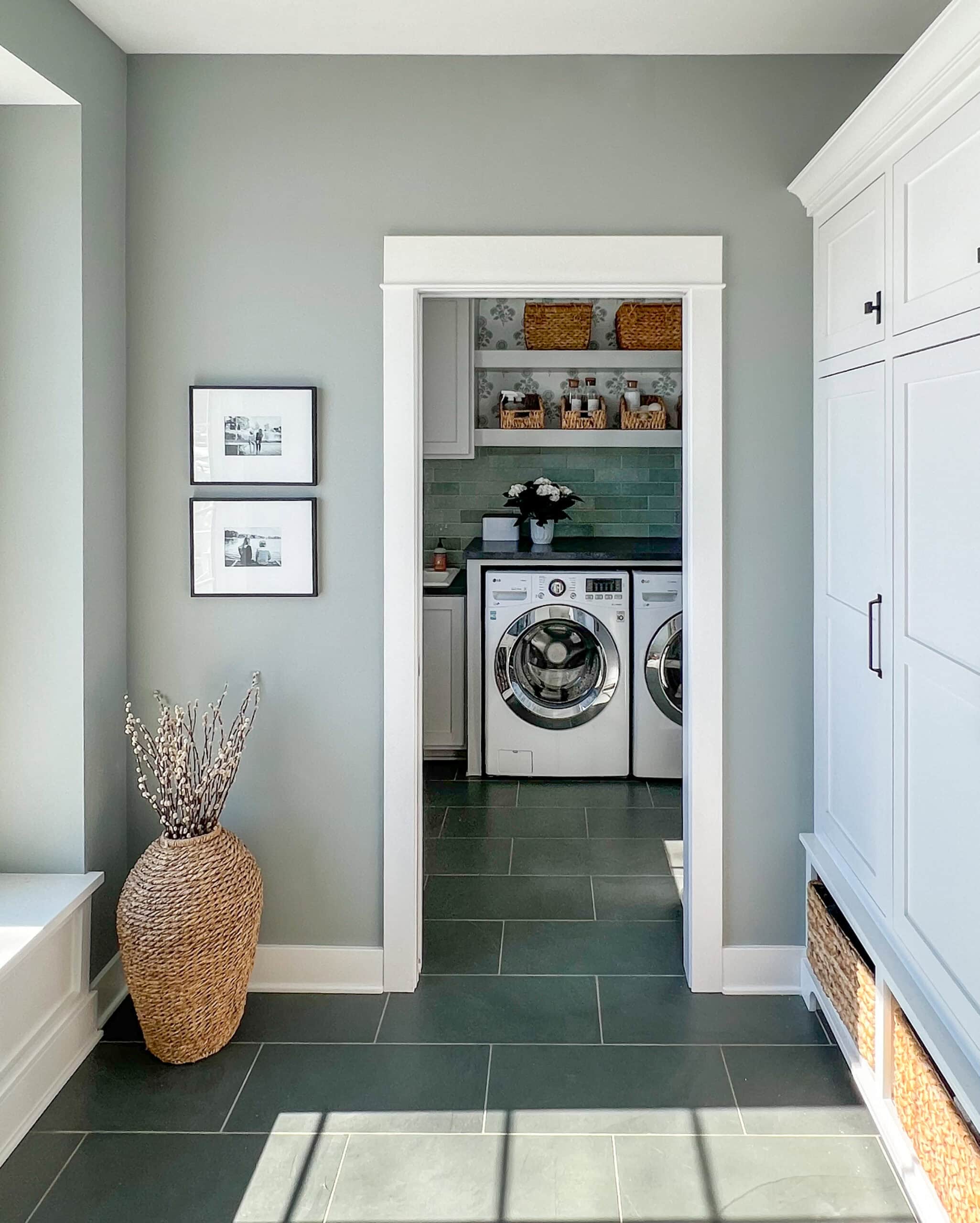 mudroom with adjacent laundry room with slate floors