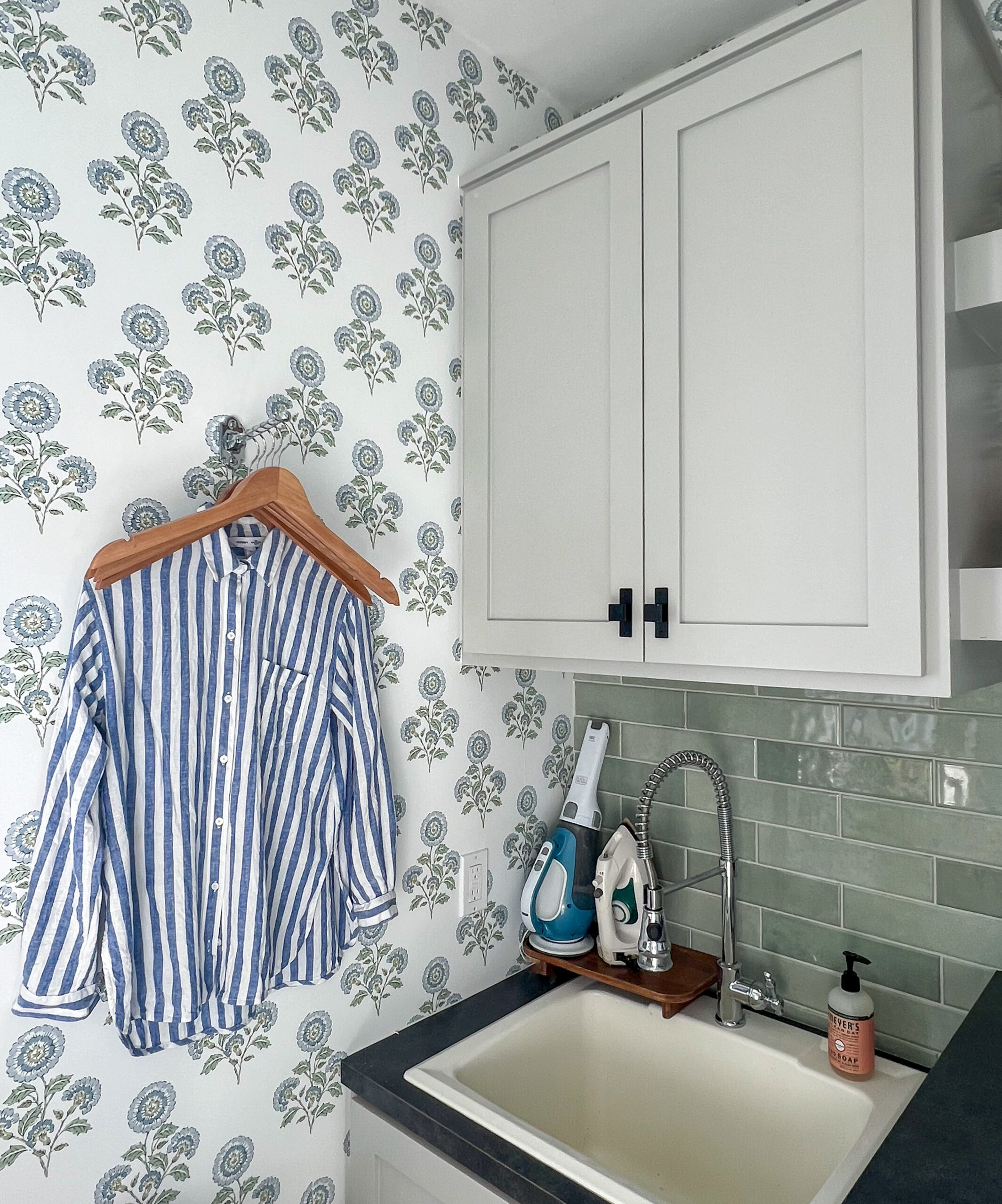 laundry room with gray cabinets and chrome valet hook