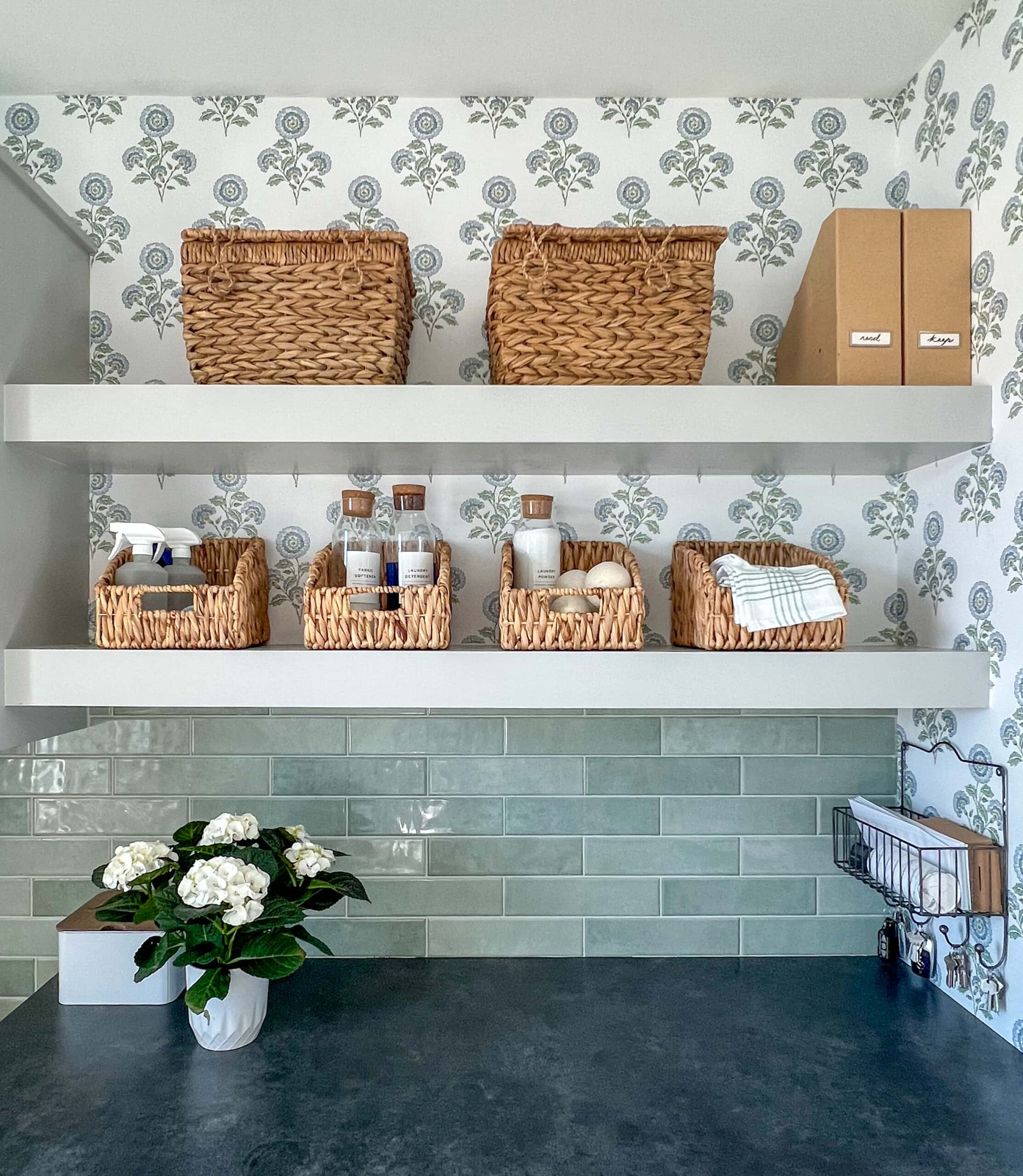 laundry room with open shelves and floral wallpaper