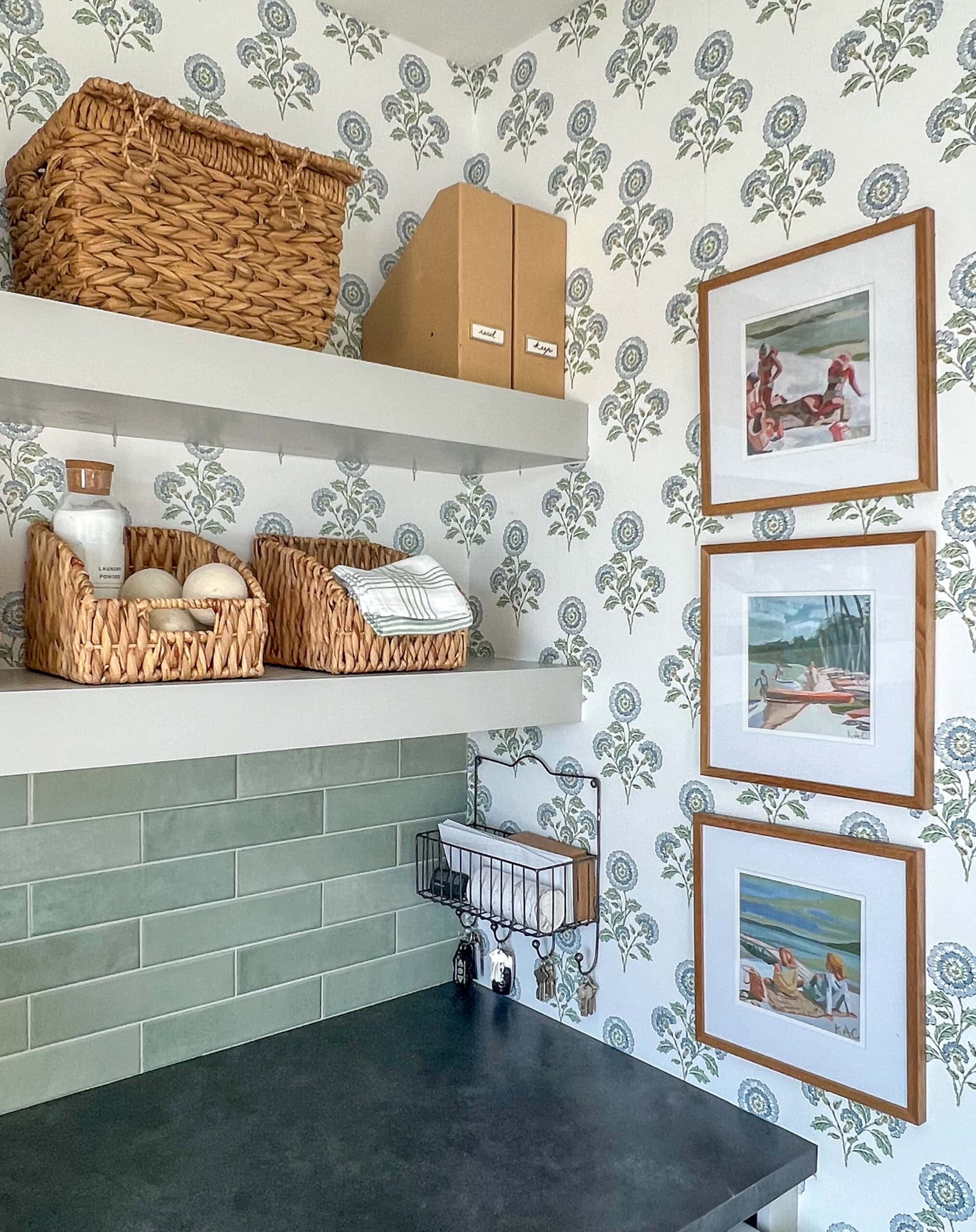 floral wallpapered laundry room with green tile backslash