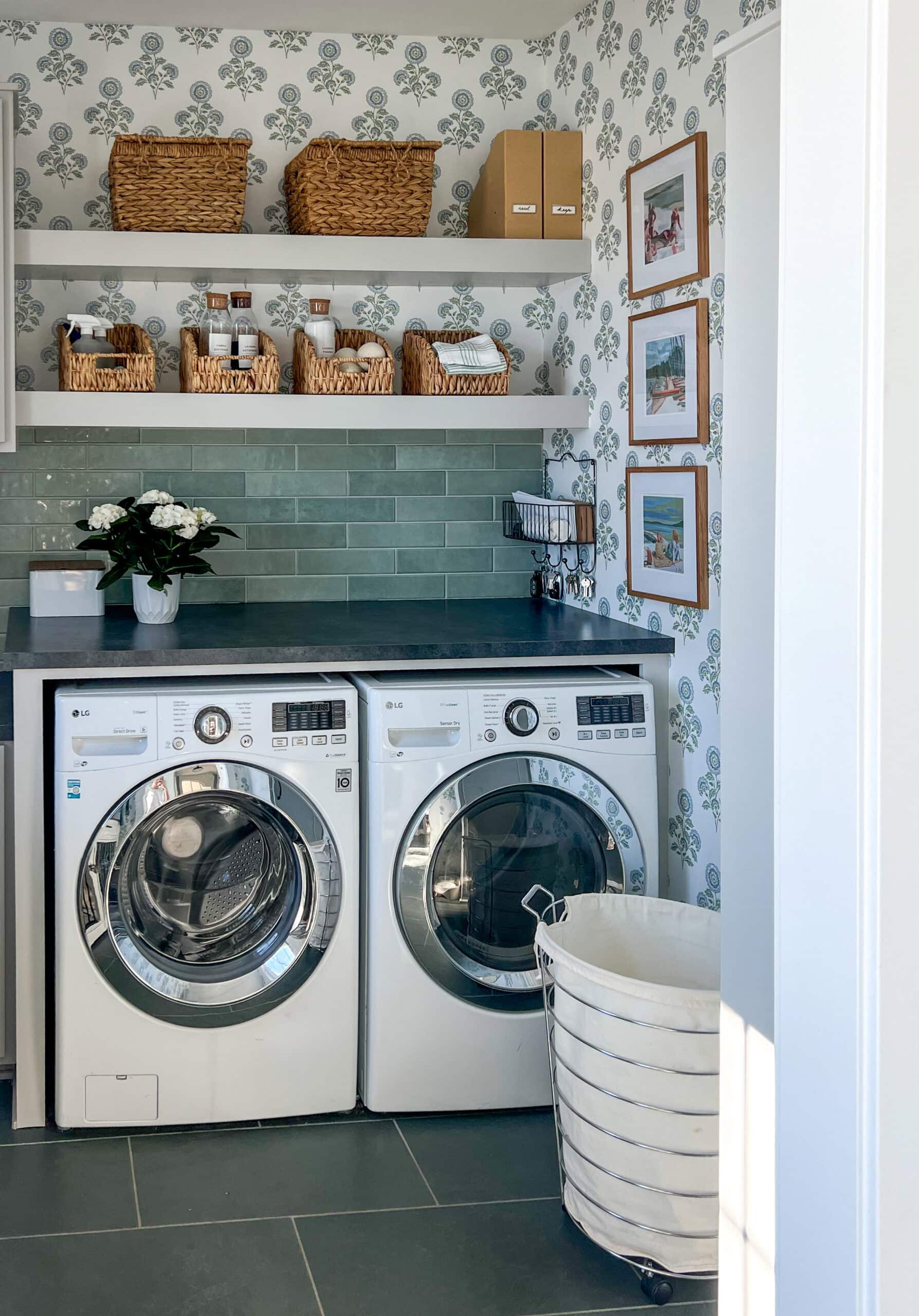 laundry room with blue and green floral wallpaper and slate floors